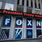 A headline about President Donald Trump is displayed outside Fox News studios in New York on Nov. 28, 2018. Documents in defamation lawsuit illustrate pressures faced by Fox News journalists in the weeks after the 2020 presidential election. The network was on a collision course between giving its conservative audience what it wanted and reporting uncomfortable truths about then-President Donald Trump and his false fraud claims. (AP Photo/Mark Lennihan, File)