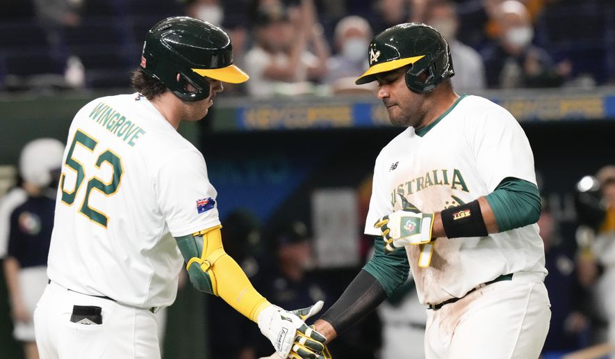 Darryl George, right, of Australia is congratulated by teammate Rixon Wingrove after completing a home run during their Pool B game against Chinaat the World Baseball Classic at the Tokyo Dome, Japan, Saturday, March 11, 2023. (AP Photo/Eugene Hoshiko)