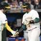 Darryl George, right, of Australia is congratulated by teammate Rixon Wingrove after completing a home run during their Pool B game against Chinaat the World Baseball Classic at the Tokyo Dome, Japan, Saturday, March 11, 2023. (AP Photo/Eugene Hoshiko)