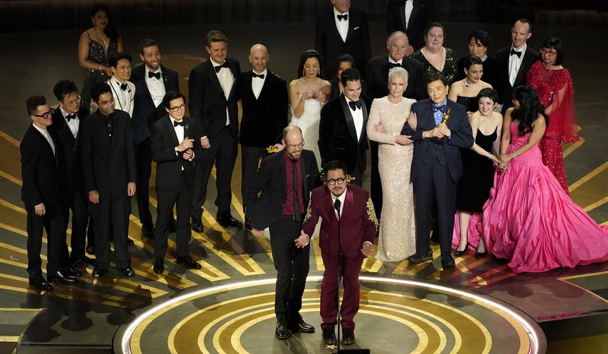 The cast and crew of &quot;Everything Everywhere All at Once&quot; accepts the award for best picture at the Oscars on Sunday, March 12, 2023, at the Dolby Theatre in Los Angeles. (AP Photo/Chris Pizzello)