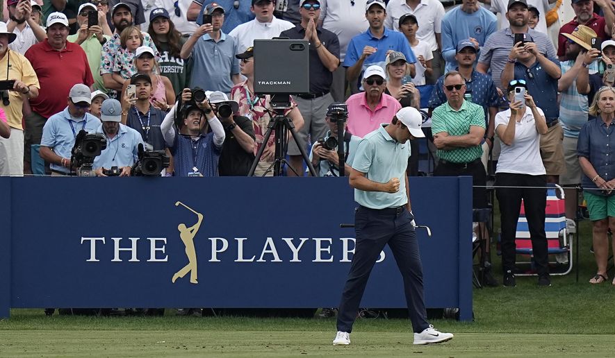 Scottie Scheffler reacts after hitting from the 17th tee during the final round of The Players Championship golf tournament, Sunday, March 12, 2023, in Ponte Vedra Beach, Fla. (AP Photo/Eric Gay)