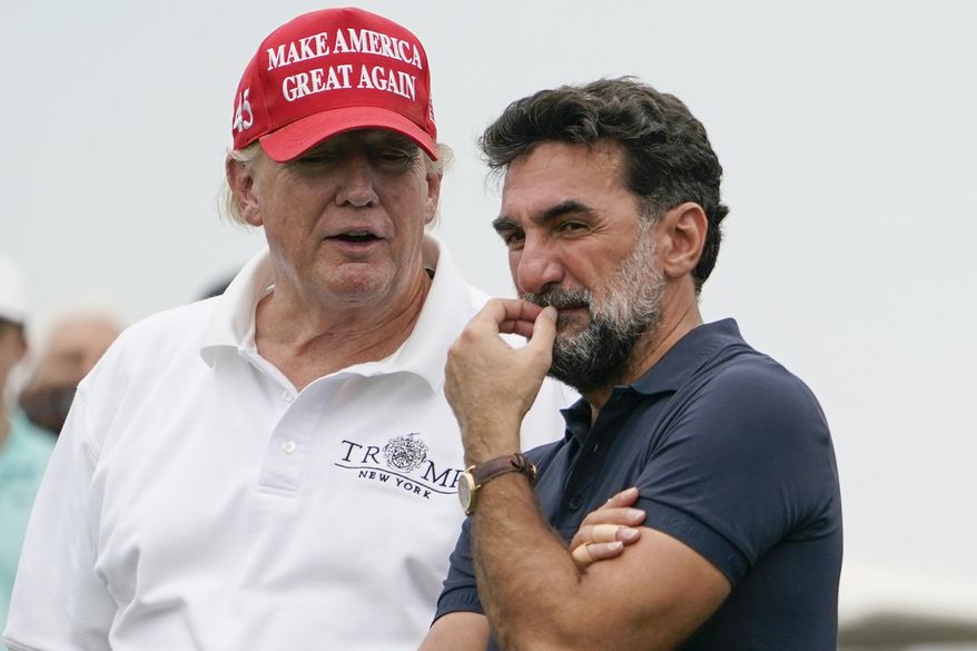 Former President Donald Trump, left, talks with Yasir Al-Rumayyan, governor of Saudi Arabia&#x27;s Public Investment Fund, center, and Majed Al-Sorour, CEO of Golf Saudi, on the 16th hole during the first round of the Bedminster Invitational LIV Golf tournament in Bedminster, NJ., July 29, 2022. (AP Photo/Seth Wenig, File)