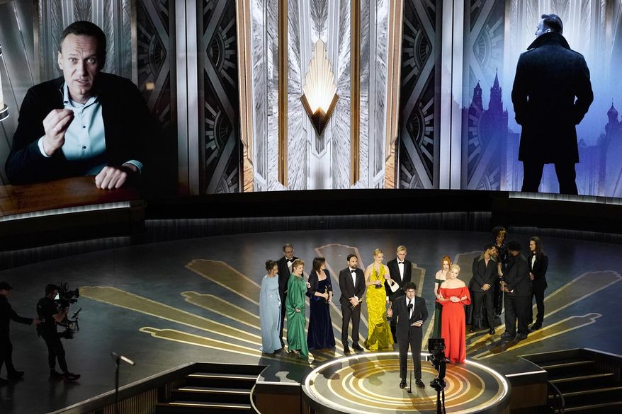 Daniel Roher and the members of the crew from &quot;Navalny&quot; accept the award for best documentary feature film at the Oscars on Sunday, March 12, 2023, at the Dolby Theatre in Los Angeles. (AP Photo/Chris Pizzello)