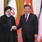 In this photo released by Xinhua News Agency, visiting Iranian President Ebrahim Raisi, left, shakes hands with Chinese President Xi Jinping before their meeting at the Great Hall of the People in Beijing, Feb. 14, 2023. (Yan Yan/Xinhua via AP, File)