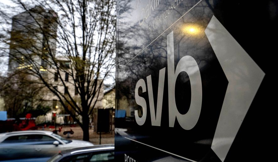 A sign of a branch of the Silicon Valley Bank is pictured at an office building where the bank is located in Frankfurt, Germany, Monday, March 13, 2023. (AP Photo/Michael Probst)
