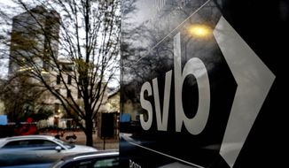 A sign of a branch of the Silicon Valley Bank is pictured at an office building where the bank is located in Frankfurt, Germany, Monday, March 13, 2023. (AP Photo/Michael Probst)