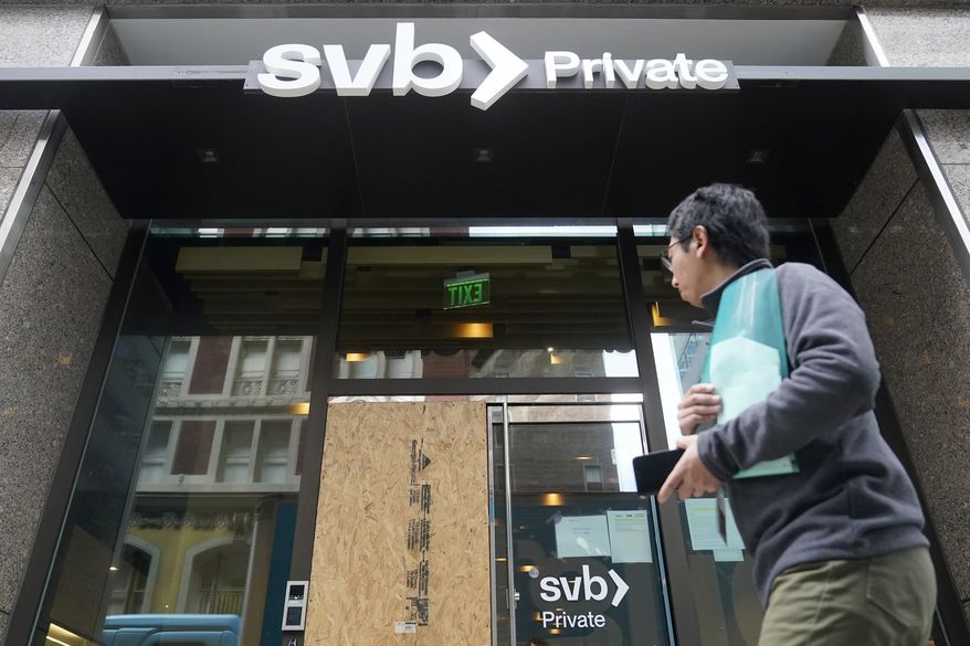 A pedestrian passes a Silicon Valley Bank Private branch in San Francisco, Monday, March 13, 2023. Depositors withdrew savings and investors broadly sold off bank shares Monday as the federal government raced to reassure Americans that the banking system was secure after two bank failures. Regulators closed the Silicon Valley Bank on Friday after depositors rushed to withdraw their funds all at once.  (AP Photo/Jeff Chiu)