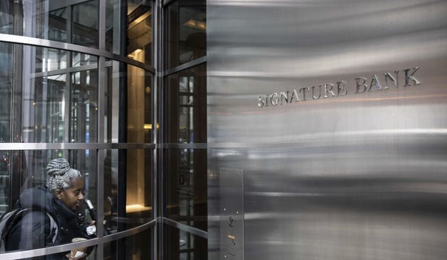 A person enters the Signature Bank headquarters in New York, Monday, March 13, 2023. President Joe Biden is telling Americans that the nation’s financial systems are sound. This comes after the swift and stunning collapse of two banks that prompted fears of a broader upheaval. (AP Photo/Yuki Iwamura)