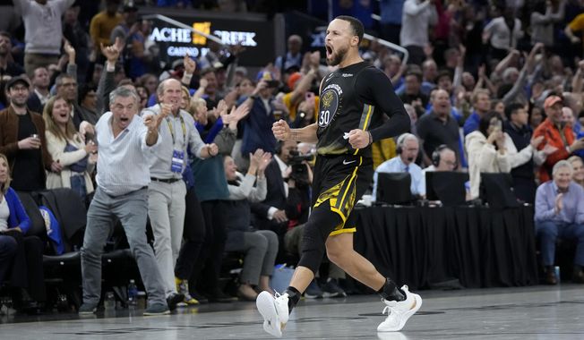 Golden State Warriors guard Stephen Curry (30) celebrates after making a 3-point basket during the second half of an NBA basketball game against the Milwaukee Bucks in San Francisco, Saturday, March 11, 2023. (AP Photo/Jeff Chiu)