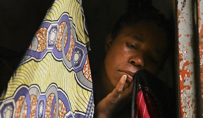 A woman at a displacement center in Blantyre, Malawi Tuesday March 14, 2023. The unrelenting Cyclone Freddy that is currently battering southern Africa has killed more than 50 people in Malawi and Mozambique since it struck the continent for a second time on Saturday night. (AP Photo/Thoko Chikondi)