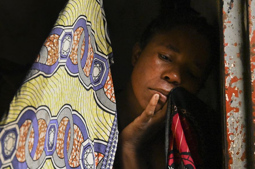 A woman at a displacement center in Blantyre, Malawi Tuesday March 14, 2023. The unrelenting Cyclone Freddy that is currently battering southern Africa has killed more than 50 people in Malawi and Mozambique since it struck the continent for a second time on Saturday night. (AP Photo/Thoko Chikondi)