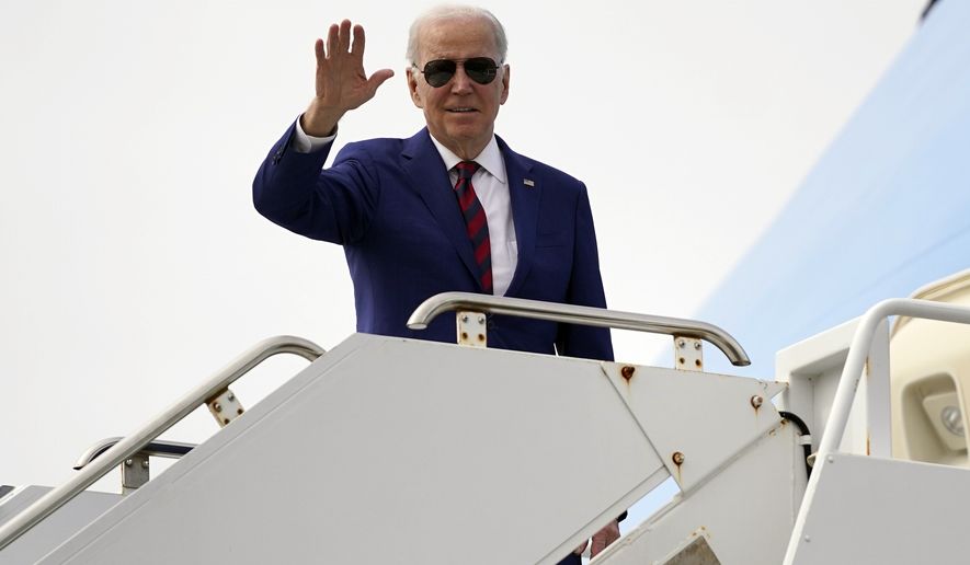 President Joe Biden waves as he boards Air Force One at North Island Naval Air Station, Tuesday, March 14, 2023, in San Diego. (AP Photo/Evan Vucci)