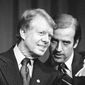 In this Feb. 20, 1978, file photo, President Jimmy Carter listens to Sen. Joseph R. Biden, D-Del., as they wait to speak at fund raising reception at Padua Academy in Wilmington, Del. President Joe Biden says he plans to deliver the eulogy at the funeral of former President Jimmy Carter, who remains under hospice care at his home in south Georgia. (AP Photo/Barry Thumma, File)