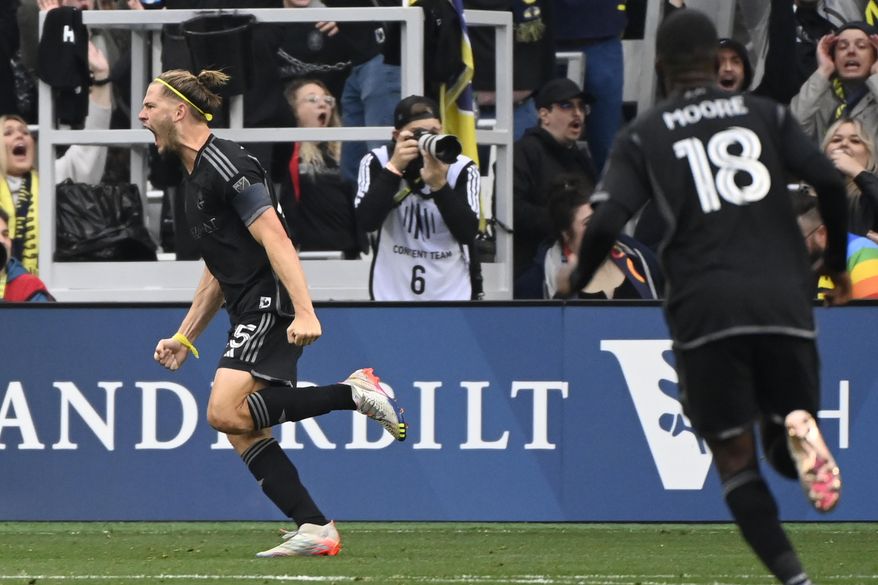 Nashville SC defender Walker Zimmerman, left, celebrates his goal against New York City FC during the first half of an MLS soccer match Saturday, Feb. 25, 2023, in Nashville, Tenn. (AP Photo/Mark Zaleski)