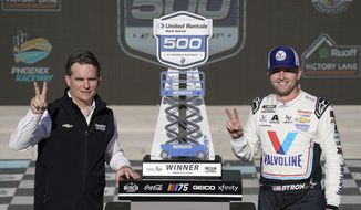 NASCAR legend Jeff Gordon, left, and William Byron, pose with Byron&#x27;s trophy after winning the NASCAR Cup Series auto race at Phoenix Raceway, Sunday, March 12, 2023, in Avondale, Ariz. (AP Photo/Darryl Webb)