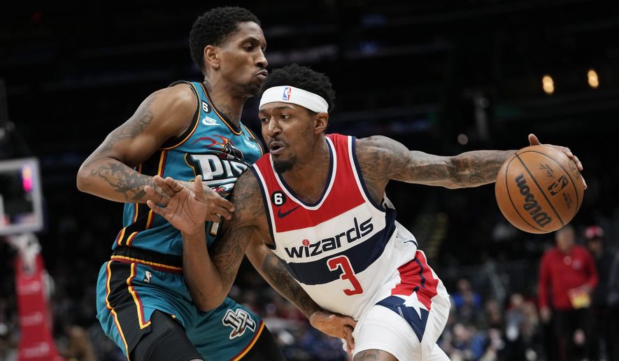 Washington Wizards guard Bradley Beal (3) drives around Detroit Pistons guard Rodney McGruder during the first half of an NBA basketball game Tuesday, March 14, 2023, in Washington. (AP Photo/Carolyn Kaster)