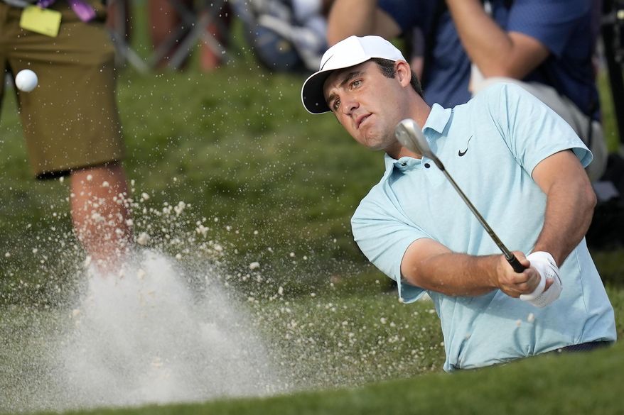 Scottie Scheffler hits from a bunker toward the 16th green during the final round of The Players Championship golf tournament, Sunday, March 12, 2023, in Ponte Vedra Beach, Fla. (AP Photo/Charlie Neibergall) **FILE**
