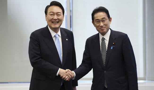 South Korean President Yoon Suk Yeol, left, shakes hands with Japanese Prime Minister Fumio Kishida before their meeting in New York on Sept. 21, 2022. South Korea’s president wants Japan to join his efforts to improve ties frayed over Tokyo’s past colonial rule, saying there is an increasing need for greater bilateral cooperation because of North Korean nuclear threats and global supply chain challenges. (Ahn Jung-won/Yonhap via AP, File)