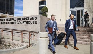Erik Baptist, right, and other legal team members with Alliance Defending Freedom exit the federal court building on Wednesday, March 15, 2023, in Amarillo, Texas, where a federal judge is expected to hear arguments in a lawsuit that takes aim at medication abortions. Pills are the the most common method for obtaining an abortion in the U.S. (AP Photo/David Erickson)