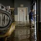 Patrick Cerruti assesses damage of his daughter&#x27;s flooded laundry mat, Pajaro Coin Laundry, on Salinas Road in Pajaro, Calif. on Tuesday, March 14, 2023. A levee failure prompted overnight evacuations on Friday, March 10, and into the next day.(Brontë Wittpenn/San Francisco Chronicle via AP)