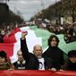 People carry a huge Hungarian flag during a march, marking the 175th anniversary of a failed 1848 uprising, in Budapest, Hungary, Wednesday, March 15, 2023. A &quot;freedom march&quot; was organized by dozens of civic organizations who are calling for greater social solidarity and an end to what they call intimidation from Viktor Orban&#x27;s government. (AP Photo/Denes Erdos)