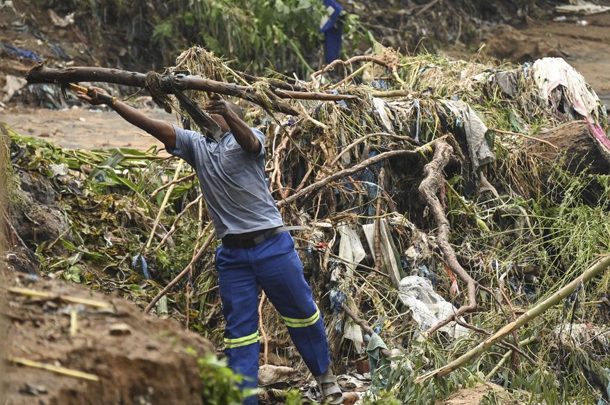 A men salvages branches from a flooded river as he tries to rebuild his home, destroyed following heavy rains caused by Cyclone Freddy in Blantyre, southern Malawi, Wednesday, March 15, 2023. After barreling through Mozambique and Malawi since late last week and killing hundreds and displacing thousands more, the cyclone is set to move away from land bringing some relief to regions who have been ravaged by torrential rain and powerful winds. (AP Photo/Thoko Chikondi)