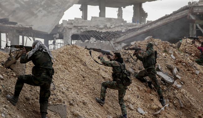 Syrian army soldiers fire their weapons during a battle with rebel fighters at the Ramouseh front line, east of Aleppo, Syria, Monday, Dec. 5, 2016. (AP Photo/Hassan Ammar, File)