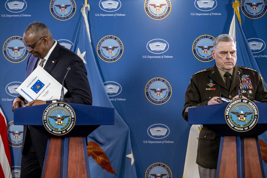 Secretary of Defense Lloyd Austin, left, and Chairman of the Joint Chiefs, Gen. Mark Milley, depart after speaking at a briefing at the Pentagon in Washington, Wednesday, March 15, 2023. (AP Photo/Andrew Harnik)