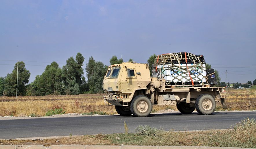 A U.S. military vehicle, part of a convoy, arrives near Dahuk, Iraq, Oct. 21, 2019. Twenty years after the U.S. invaded Iraq, in blinding explosions of shock and awe, American forces remain in the country in what has become a small, but consistent presence to ensure an ongoing relationship with a key military and diplomatic partner in the Middle East. (AP Photo/File)