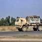 A U.S. military vehicle, part of a convoy, arrives near Dahuk, Iraq, Oct. 21, 2019. Twenty years after the U.S. invaded Iraq, in blinding explosions of shock and awe, American forces remain in the country in what has become a small, but consistent presence to ensure an ongoing relationship with a key military and diplomatic partner in the Middle East. (AP Photo/File)