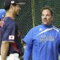Japan team pitcher Yu Darvish, center, and Italy team manager Mike Piazza chat during a practice session at the Tokyo Dome in Tokyo, Wednesday, March 15, 2023. (Kyodo News via AP)