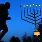 A jogger passes a large menorah on Independence Mall on the seventh night of Hanukkah, Tuesday, Dec. 3, 2013, in Philadelphia. Hanukkah is the Jewish Festival of Lights, an eight-day commemoration of rededication of the Temple by the Maccabees after their victory over the Syrians. (AP Photo/Matt Rourke) **FILE**