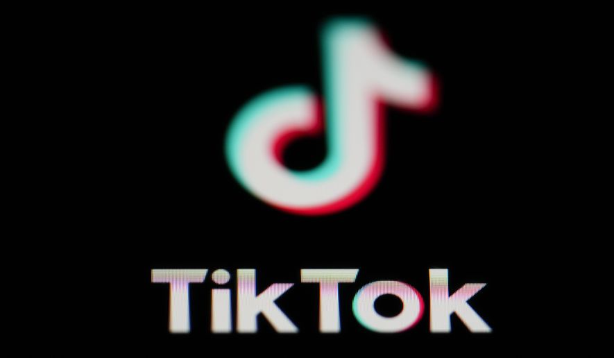 The icon for the video-sharing TikTok app is seen on a smartphone, on Feb. 28, 2023. China accused the United States on Thursday, March 16, of spreading disinformation and suppressing TikTok following reports that the Biden administration was calling for its Chinese owners to sell their stakes in the popular video-sharing app. (AP Photo/Matt Slocum, File)