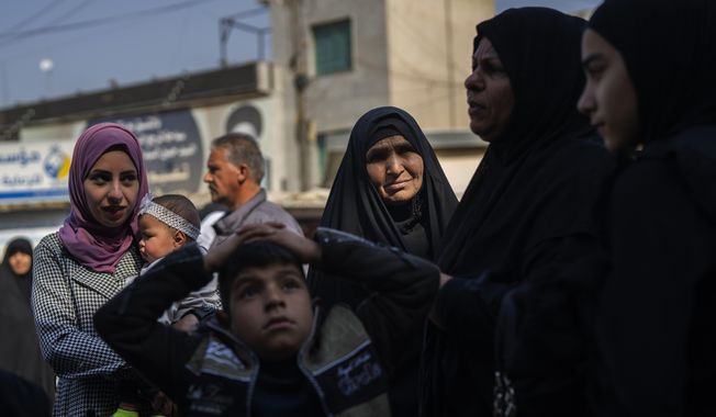 A family heads to the al-Kadhimayn shrine in Baghdad, Iraq, on Saturday, Feb. 25, 2023. For Iraqis, the war and U.S. occupation which started two decades ago were traumatic – an estimated 300,000 Iraqis were killed between 2003 and 2019, according to an estimate by the Watson Institute for International and Public Affairs at Brown University, in addition to some 4,000 Americans. (AP Photo/Jerome Delay)
