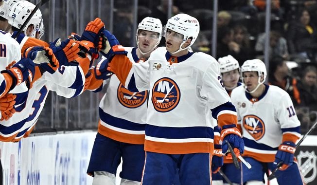 New York Islanders right wing Hudson Fasching (20) is congratulated after scoring against the Anaheim Ducks during the second period of an NHL hockey game in Anaheim, Calif., Wednesday, March 15, 2023. (AP Photo/Alex Gallardo)