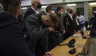 Finnegan Lee Elder, wipes his eye, as he and his co-defendant Gabriel Natale-Hjorth listen as the verdict is read, in the trial for the slaying of an Italian plainclothes police officer on a street near the hotel where they were staying while on vacation in Rome in summer 2019, in Rome, on May 5, 2021. The Court of Cassation late Wednesday, March 15, 2023, threw out the guilty verdicts against Lee Elder, now 23, and Natale-Hjorth, 22, both convicted in the stabbing death of the 35-year-old officer during a plainclothes operation while the Americans, teens at the time, were on vacation in Rome in the summer of 2019. (AP Photo/Gregorio Borgia, File)
