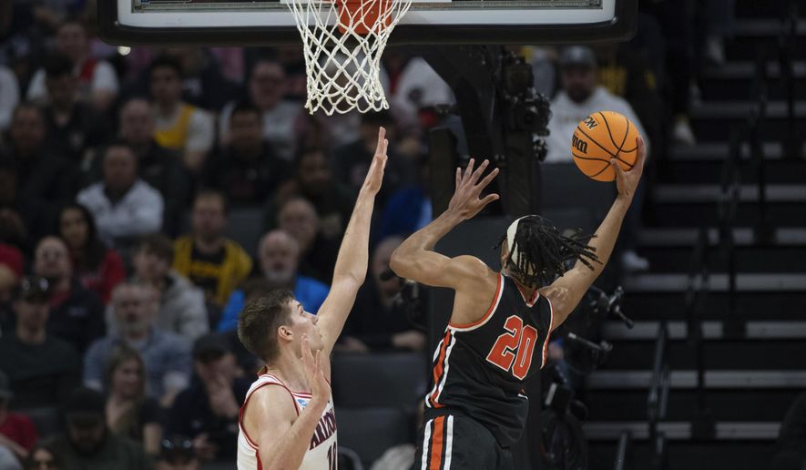 Princeton forward Tosan Evbuomwan (20) scores a basket in front of Arizona forward Azuolas Tubelis (10) during the first half of a first-round college basketball game in the NCAA Tournament in Sacramento, Calif., Thursday, March 16, 2023. (AP Photo/José Luis Villegas)