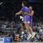 Furman forward Tyrese Hughey (15) and forward Alex Williams, right, celebrate their win against Virginia during a first-round college basketball game in the NCAA Tournament, Thursday, March 16, 2023, in Orlando, Fla. (AP Photo/Phelan M. Ebenhack)