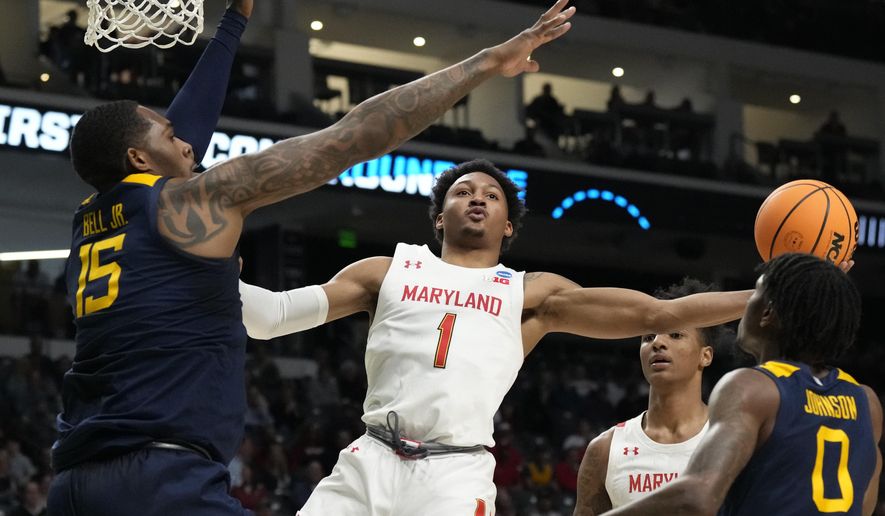 Maryland guard Jahmir Young (1) attempts a layup past West Virginia forward Jimmy Bell Jr. (15) in the first half of a first-round college basketball game in the NCAA Tournament in Birmingham, Ala., Thursday, March 16, 2023. (AP Photo/Rogelio V. Solis)