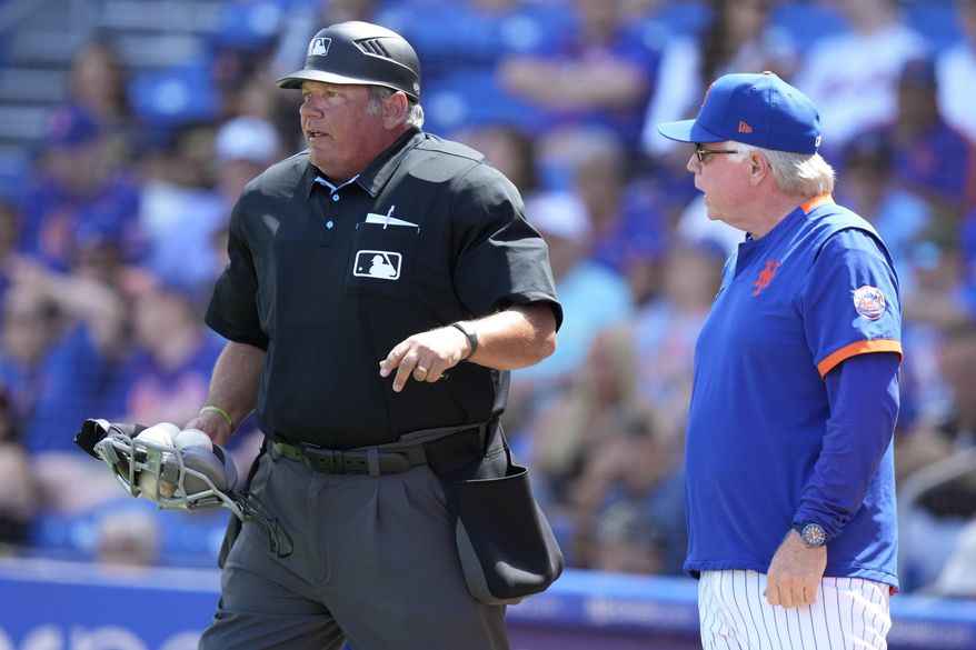 New York Mets manager Buck Showalter, right, talks with home plate umpire Hunter Wendelstedt during the third inning of a spring training baseball game against the New York Mets, Tuesday, March 14, 2023, in Port St. Lucie, Fla. (AP Photo/Lynne Sladky)