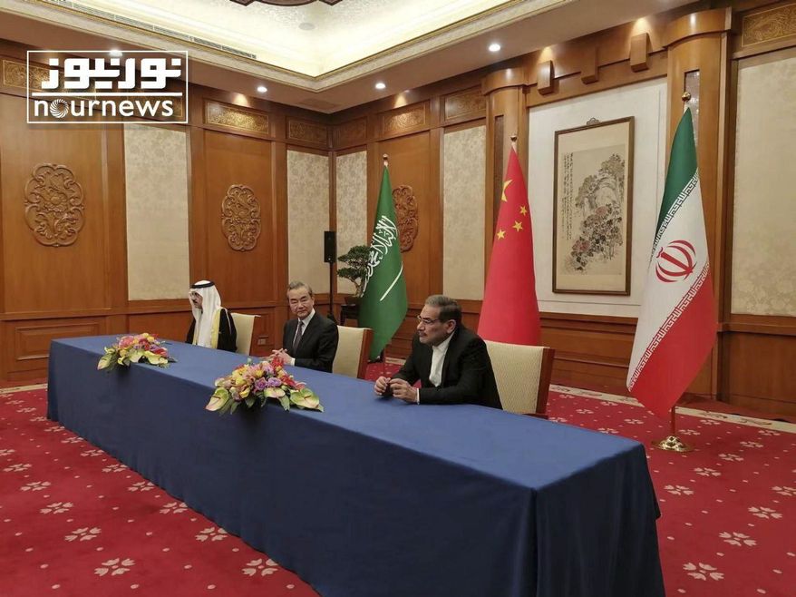 In this photo released by Nournews, Secretary of Iran&#x27;s Supreme National Security Council, Ali Shamkhani, right, China&#x27;s most senior diplomat Wang Yi, center, and Saudi Arabia&#x27;s National Security Adviser Musaad bin Mohammed al-Aiban looks on during an agreement signing ceremony between Iran and Saudi Arabia to reestablish diplomatic relations and reopen embassies after seven years of tensions between the Mideast rivals, in Beijing, China, March 10, 2023. In a matter of days, Saudi Arabia carried out blockbuster agreements with the world&#x27;s two leading powers, signing a Chinese-facilitated deal aimed at restoring diplomatic ties with its arch-nemesis Iran and announcing a massive contract to buy commercial planes from U.S. manufacturer Boeing. (Nournews via AP)