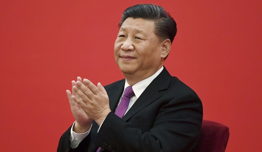 China&#x27;s President Xi Jinping claps as he listens to Russian President Vladimir Putin via a video link, from the Great Hall of the People in Beijing on Dec. 2, 2019. China said Friday, March 17, 2023, President Xi will visit Russia from Monday, March 20, to Wednesday, March 22, 2023, in an apparent show of support for Russian President Putin. (Noel Celis/Pool Photo via AP, File)