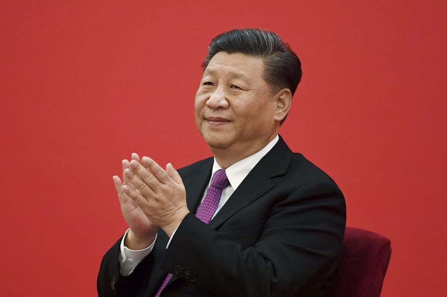 China&#x27;s President Xi Jinping claps as he listens to Russian President Vladimir Putin via a video link, from the Great Hall of the People in Beijing on Dec. 2, 2019. China said Friday, March 17, 2023, President Xi will visit Russia from Monday, March 20, to Wednesday, March 22, 2023, in an apparent show of support for Russian President Putin. (Noel Celis/Pool Photo via AP, File)