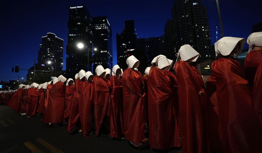Israeli women&#x27;s rights activists dressed as characters in the popular television series, &quot;The Handmaid&#x27;s Tale,&quot; protest plans by Prime Minister Benjamin Netanyahu&#x27;s government to overhaul the judicial system, in Tel Aviv, Israel, Saturday, March 11, 2023. (AP Photo/Ohad Zwigenberg, File)