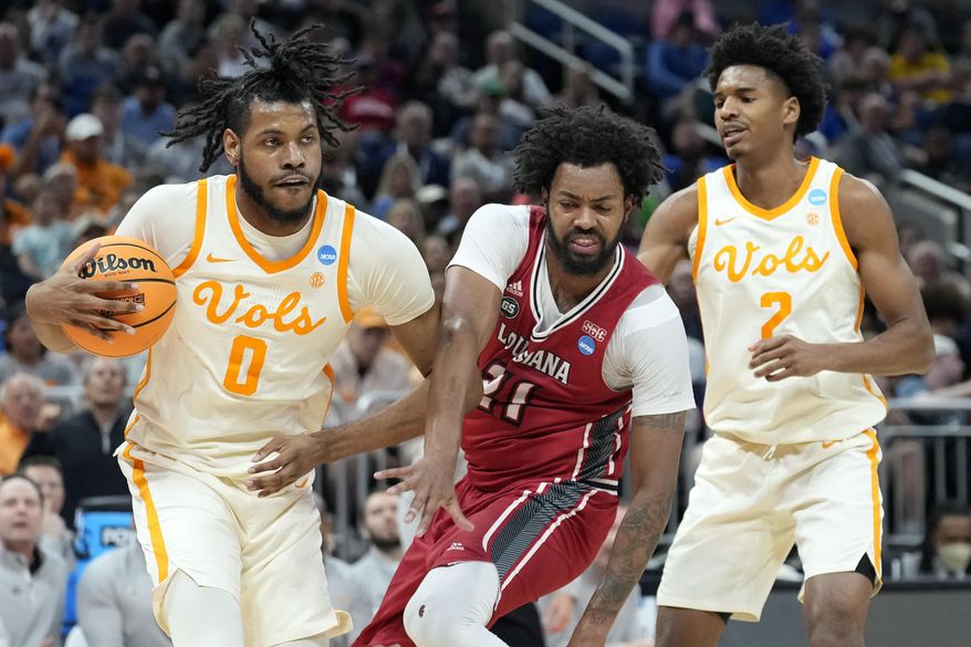 Tennessee forward Jonas Aidoo (0) steals a rebound from Louisiana forward Jordan Brown (21) during the first half of a first-round college basketball game in the NCAA Tournament, Thursday, March 16, 2023, in Orlando, Fla. Tennessee&#x27;s Julian Phillips, right, looks on. (AP Photo/Chris O&#x27;Meara)