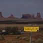 A sign marks Navajo Drive, as Sentinel Mesa, homes and other structures in Oljato-Monument Valley, Utah, on the Navajo Reservation, stand in the distance, on April 30, 2020. The U.S. Supreme Court will soon decide a critical water rights case in the water-scarce Southwest. The high court will hold oral arguments Monday, March 20, 2023, in a case with critical implications for how water from the drought-stricken Colorado River is shared and the extent of the U.S. government’s obligations to Native American tribes. (AP Photo/Carolyn Kaster, File)