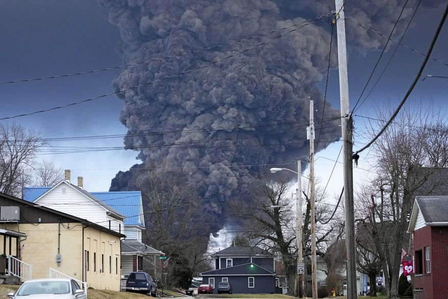 A black plume rises over East Palestine, Ohio, as a result of a controlled detonation of a portion of the derailed Norfolk Southern trains, Feb. 6, 2023. The Ohio attorney general said Tuesday, March 14, that the state filed a lawsuit against railroad Norfolk Southern to make sure it pays for the cleanup and environmental damage caused by a fiery train derailment on the Ohio-Pennsylvania border last month. (AP Photo/Gene J. Puskar, File)