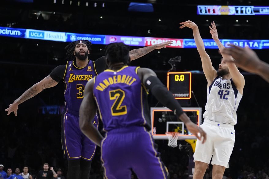 Dallas Mavericks forward Maxi Kleber (42) makes the game-winning 3-point basket over Los Angeles Lakers forward Anthony Davis (3) as time expires during the fourth quarter of an NBA basketball game Friday, March 17, 2023, in Los Angeles. (AP Photo/Marcio Jose Sanchez)