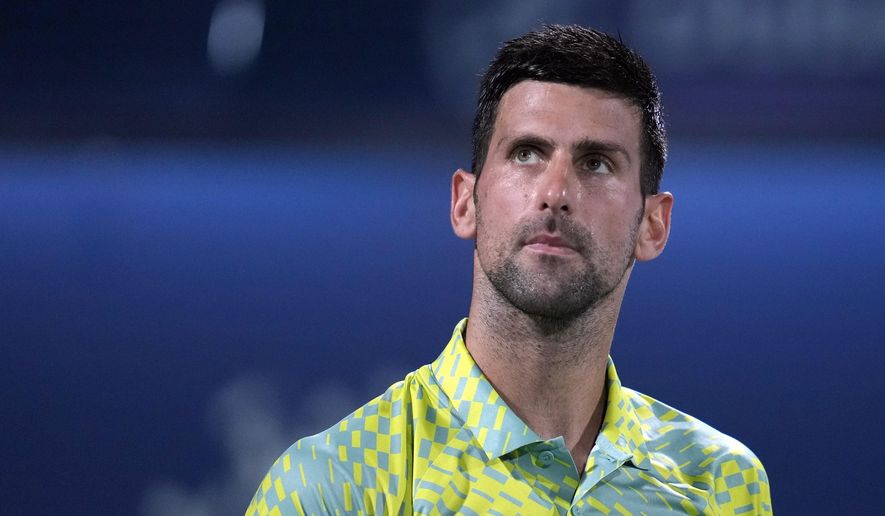 Serbia&#x27;s Novak Djokovic looks up during the quarterfinals of the Dubai Duty Free Tennis Championships in Dubai, United Arab Emirates, Thursday, March 1, 2023. Djokovic has pulled out of the Miami Open because he can’t travel to the United States as a foreign citizen who is not vaccinated against COVID-19. (AP Photo/Kamran Jebreili, File)