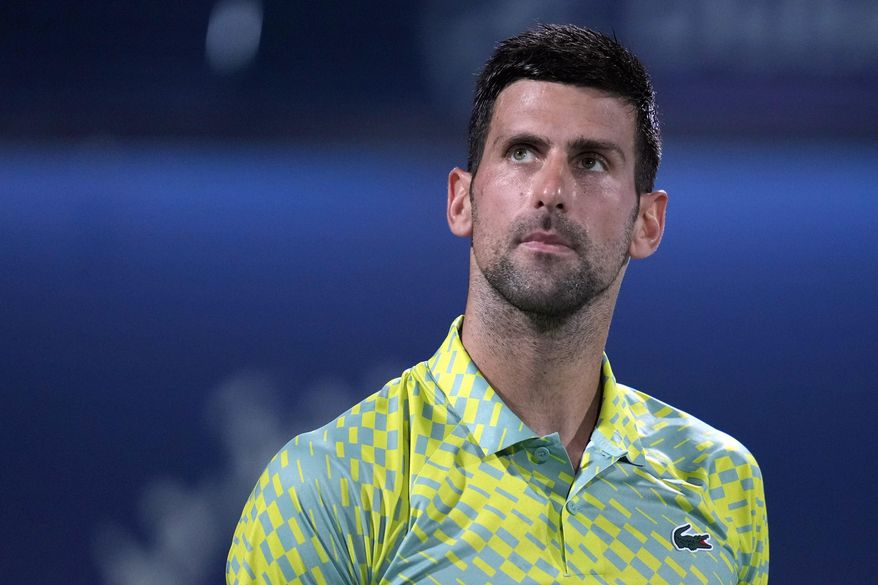 Serbia&#x27;s Novak Djokovic looks up during the quarterfinals of the Dubai Duty Free Tennis Championships in Dubai, United Arab Emirates, Thursday, March 1, 2023. Djokovic has pulled out of the Miami Open because he can’t travel to the United States as a foreign citizen who is not vaccinated against COVID-19. (AP Photo/Kamran Jebreili, File)